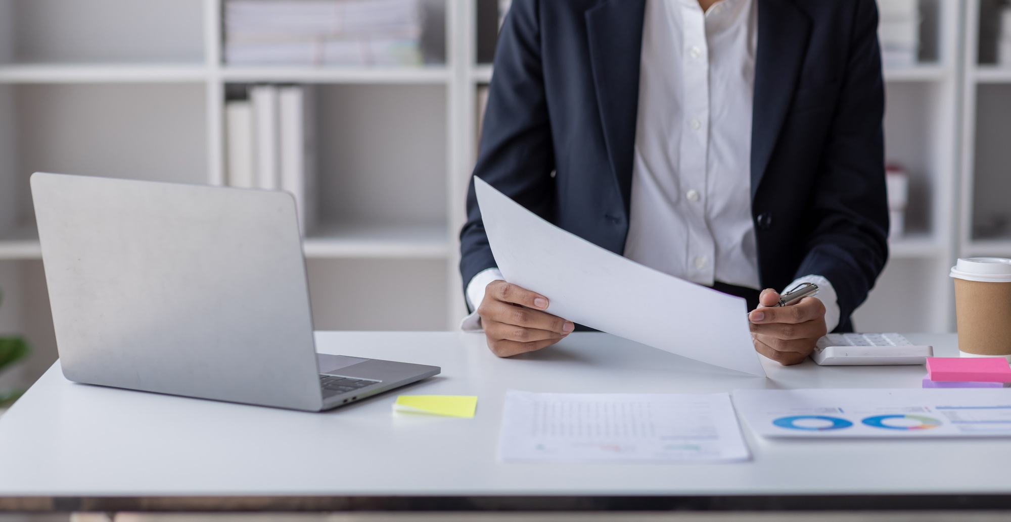 Businessman accounting working at office with calculator documents on his desk, doing planning